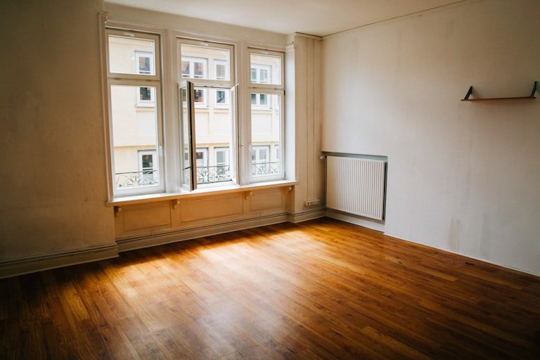 Bright empty room with wood floors, ready to furnish