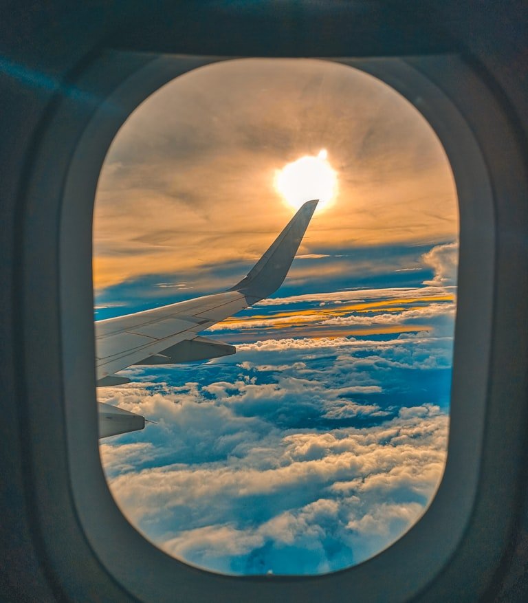 Sunset over the wing from an airplane window — owning from afar
