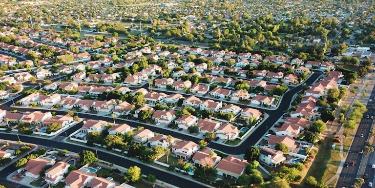 Aerial view of a sunlit residential neighborhood